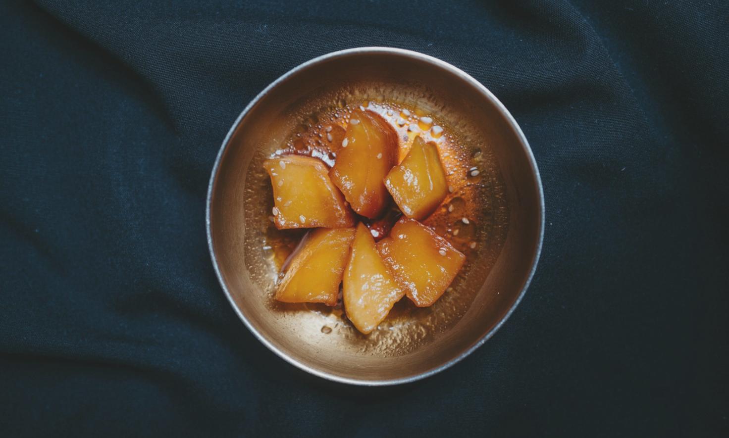 Students practicing advanced healthy cooking techniques in a learning environment